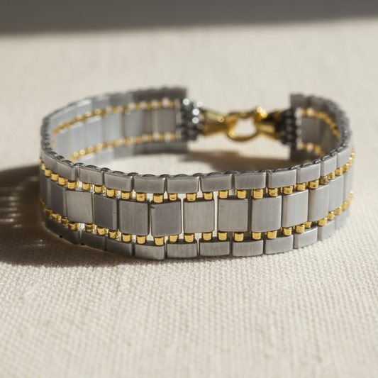 Handmade grey tila bracelet with gold accents and gol plated clasp