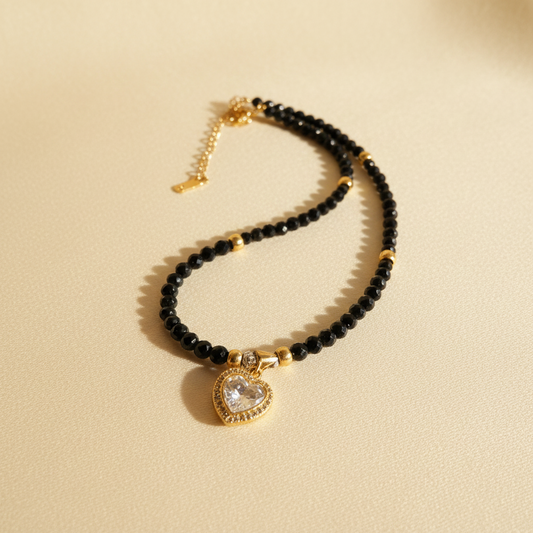 Eclipse Heart necklace with faceted black onyx beads, gold-plated accents and a sparkling heart pendant