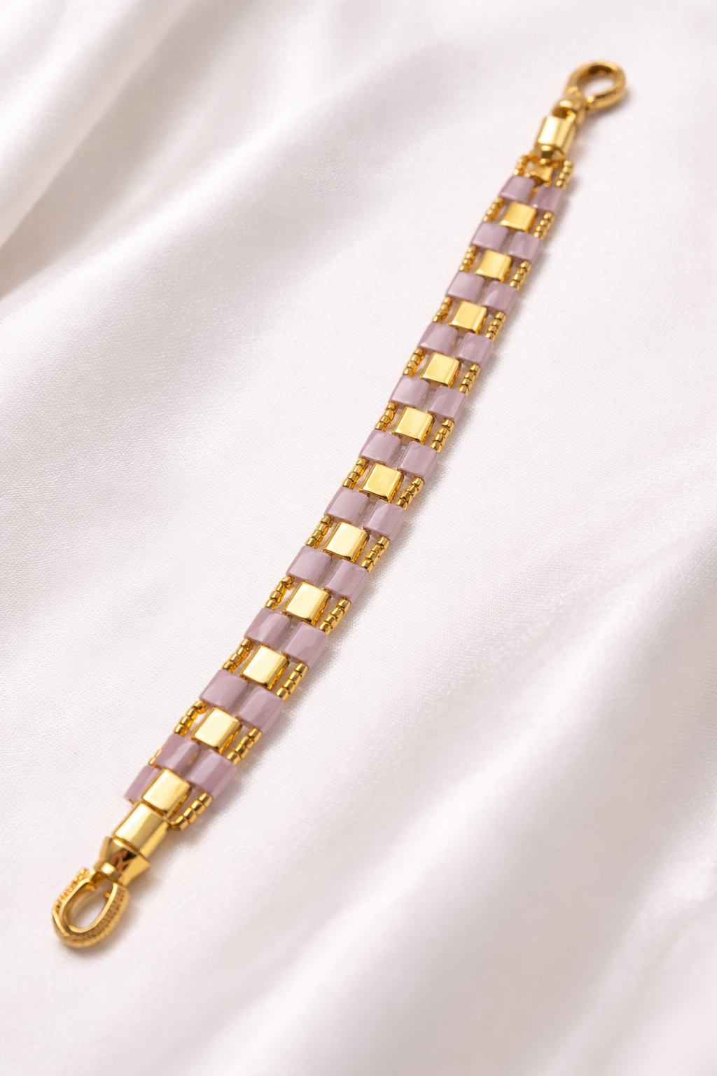 Violette Grid bracelet styled on taupe silk in a luxury jewelry setting