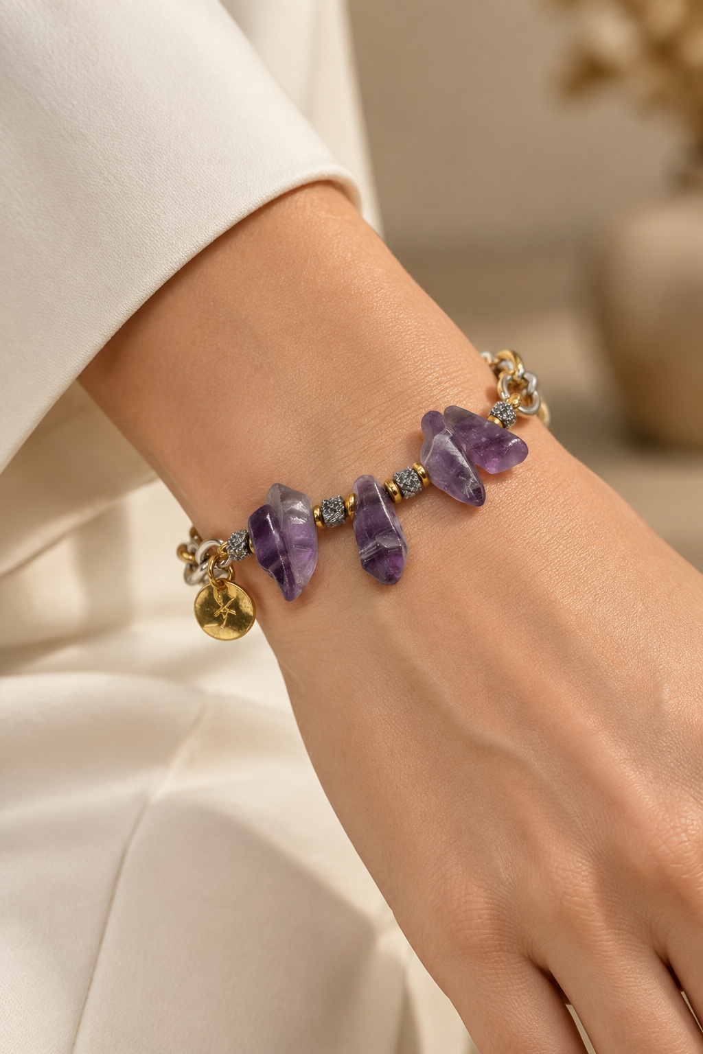 Natural amethyst and stainless steel statement bracelet worn on wrist