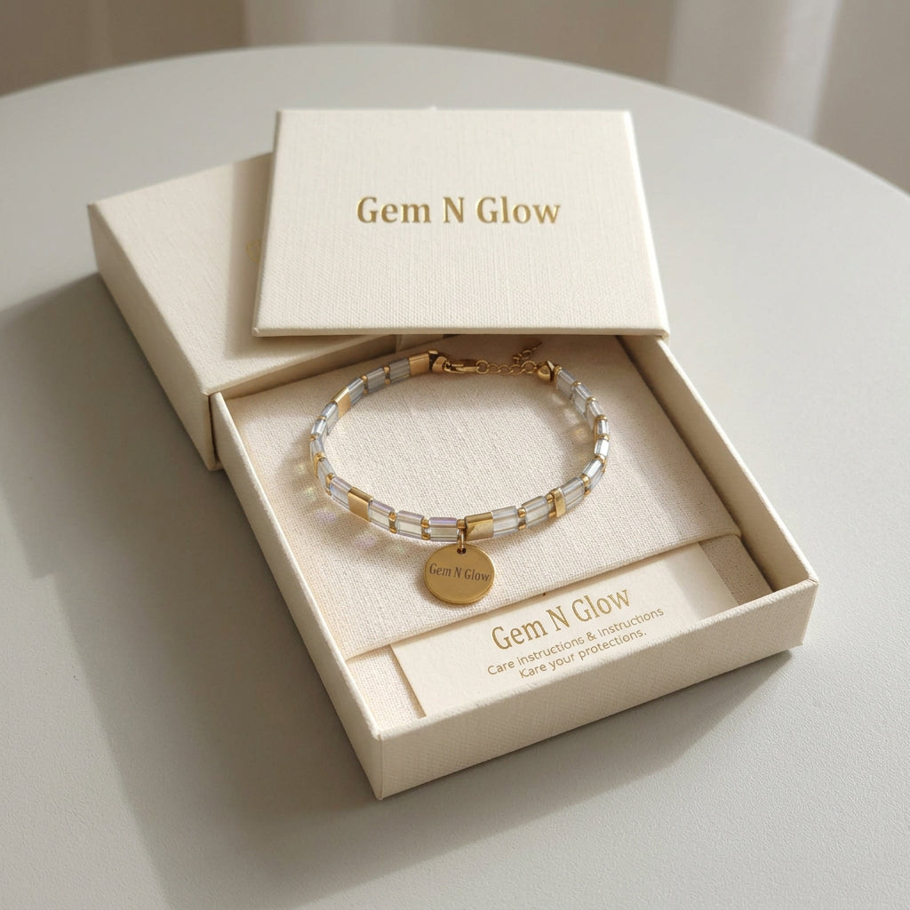 Axis Line Slim Miyuki bracelet with its branded charm displayed in Gem N Glow packaging.
