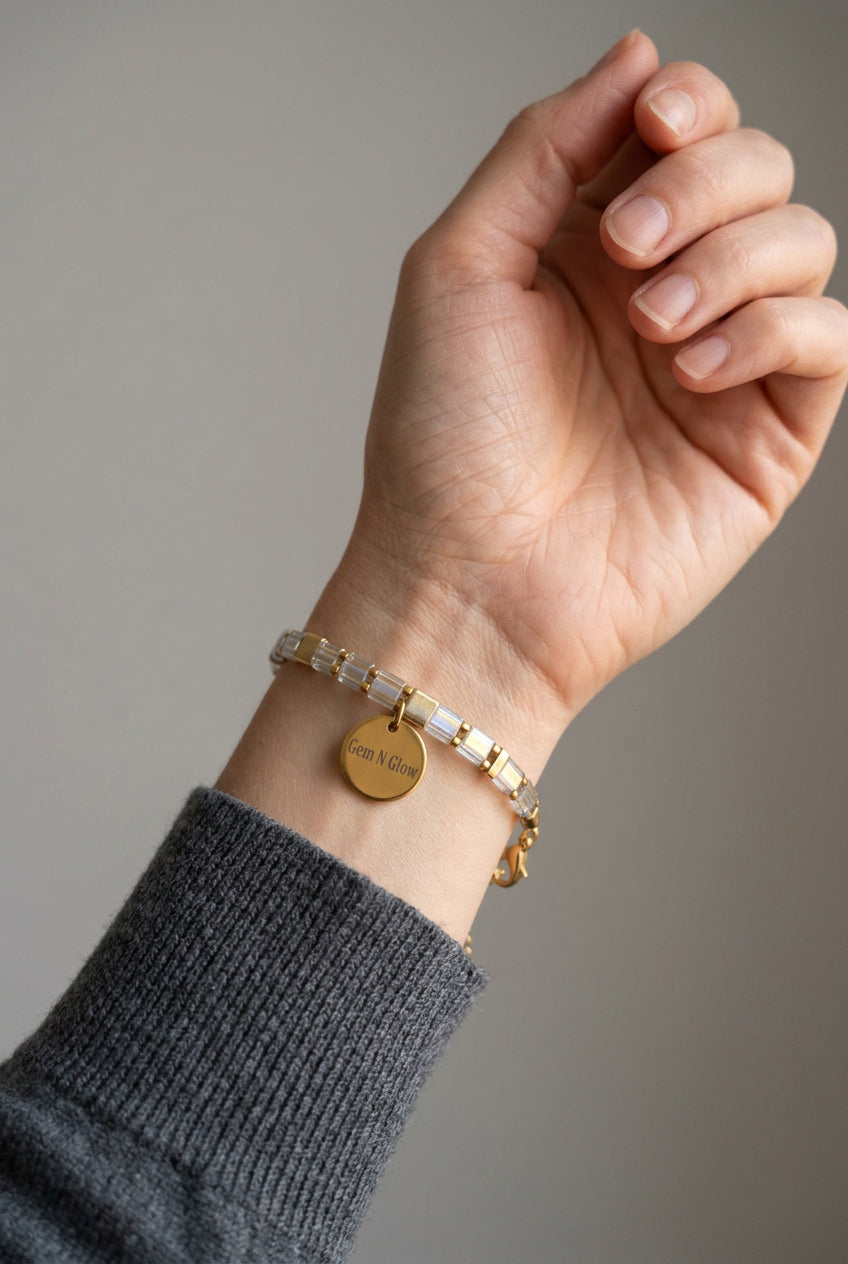 Axis Line Slim iridescent Miyuki bracelet worn on a wrist beside a charcoal knit sleeve.