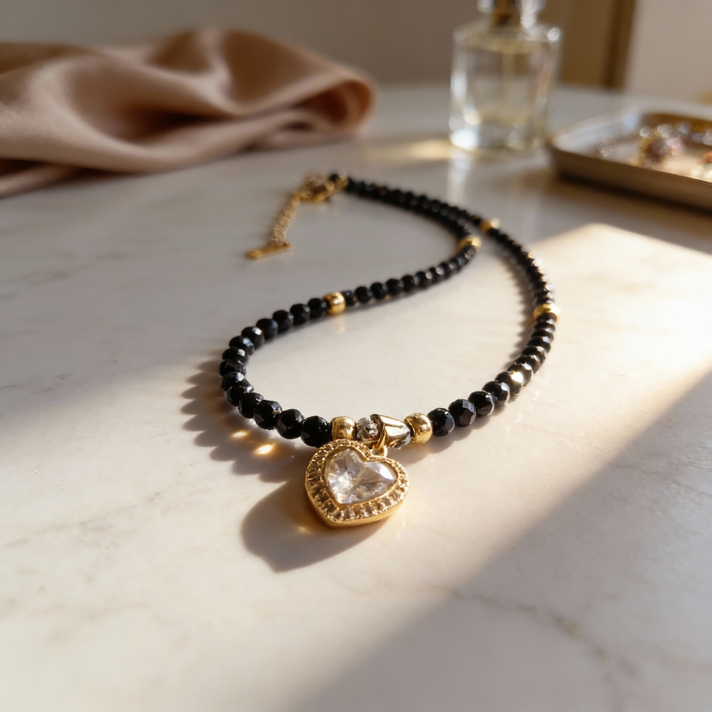 Black gemstone necklace with clear zircon heart pendant