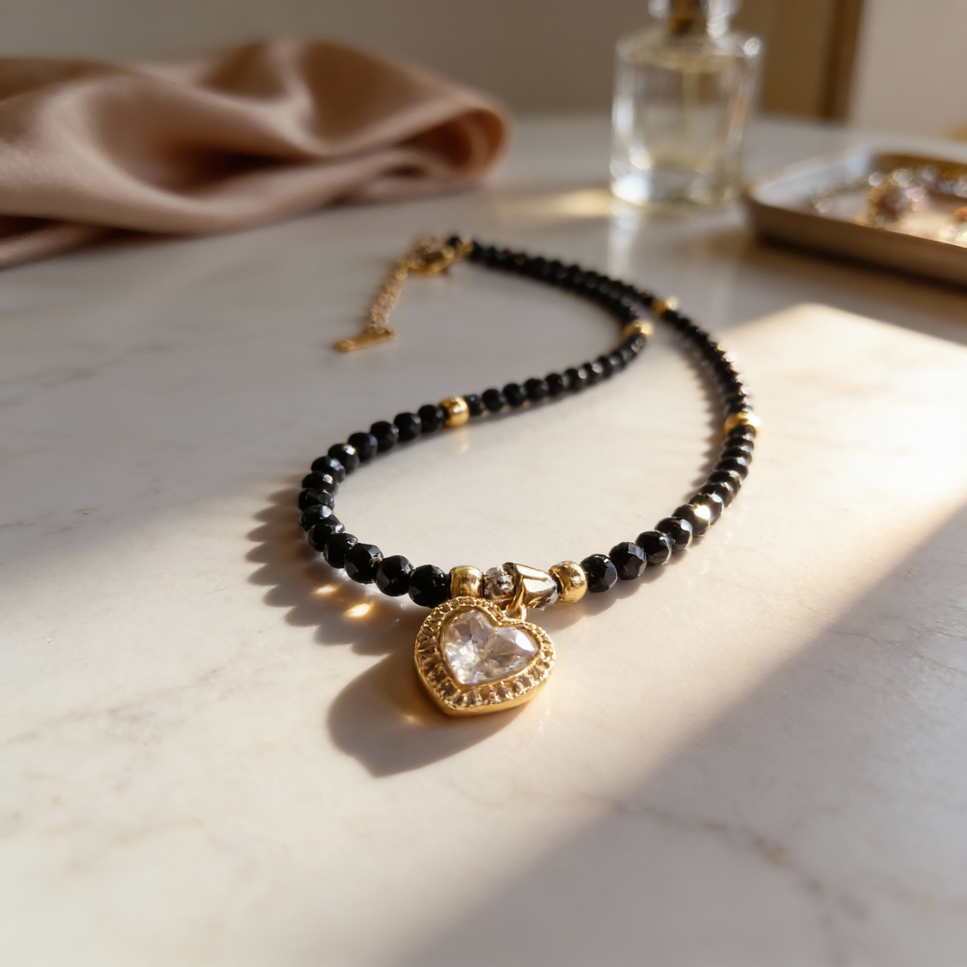 Black gemstone necklace with clear zircon heart pendant
