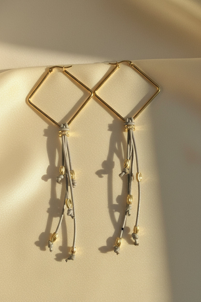 Graphite Motion Atelier Earrings with gold square hoops, grey fringe and decorative gold-tone details by Gem N Glow.