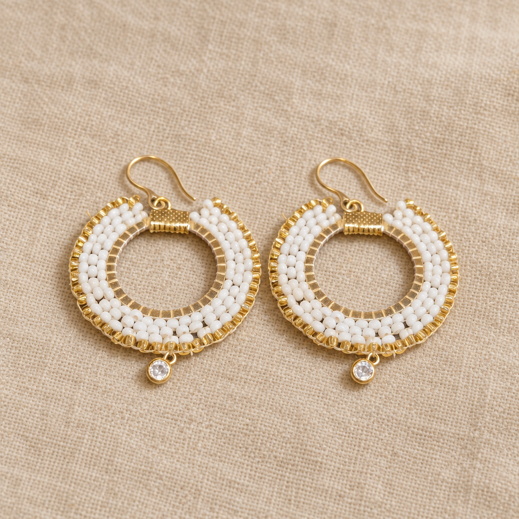 Pair of long white and gold-tone Miyuki beaded drop earrings on small sparkling hoops