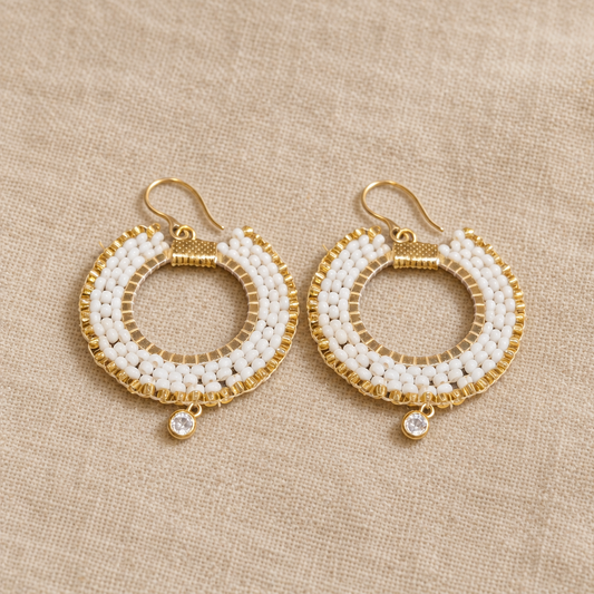 Pair of long white and gold-tone Miyuki beaded drop earrings on small sparkling hoops