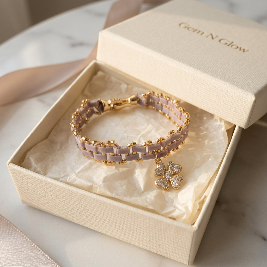 Handmade Mosaic Line Charm bracelet with lilac-grey Miyuki beads, gold-plated accents and a gold-plated clover charm embellished with cubic zirconia.