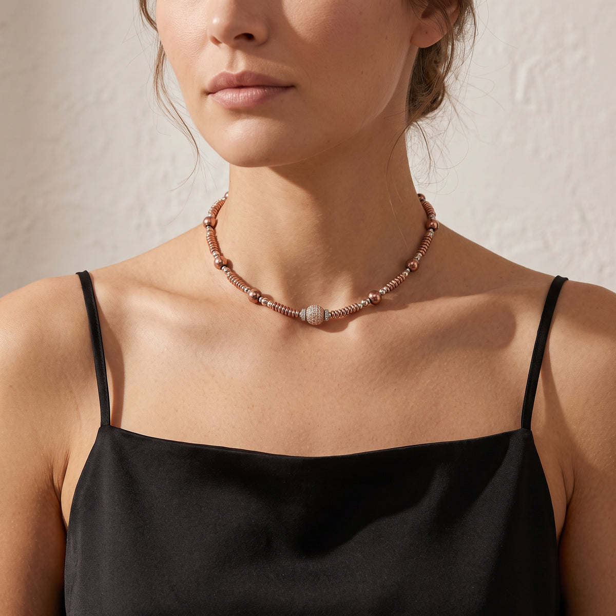 Two-tone crystal choker necklace worn around a woman’s neck