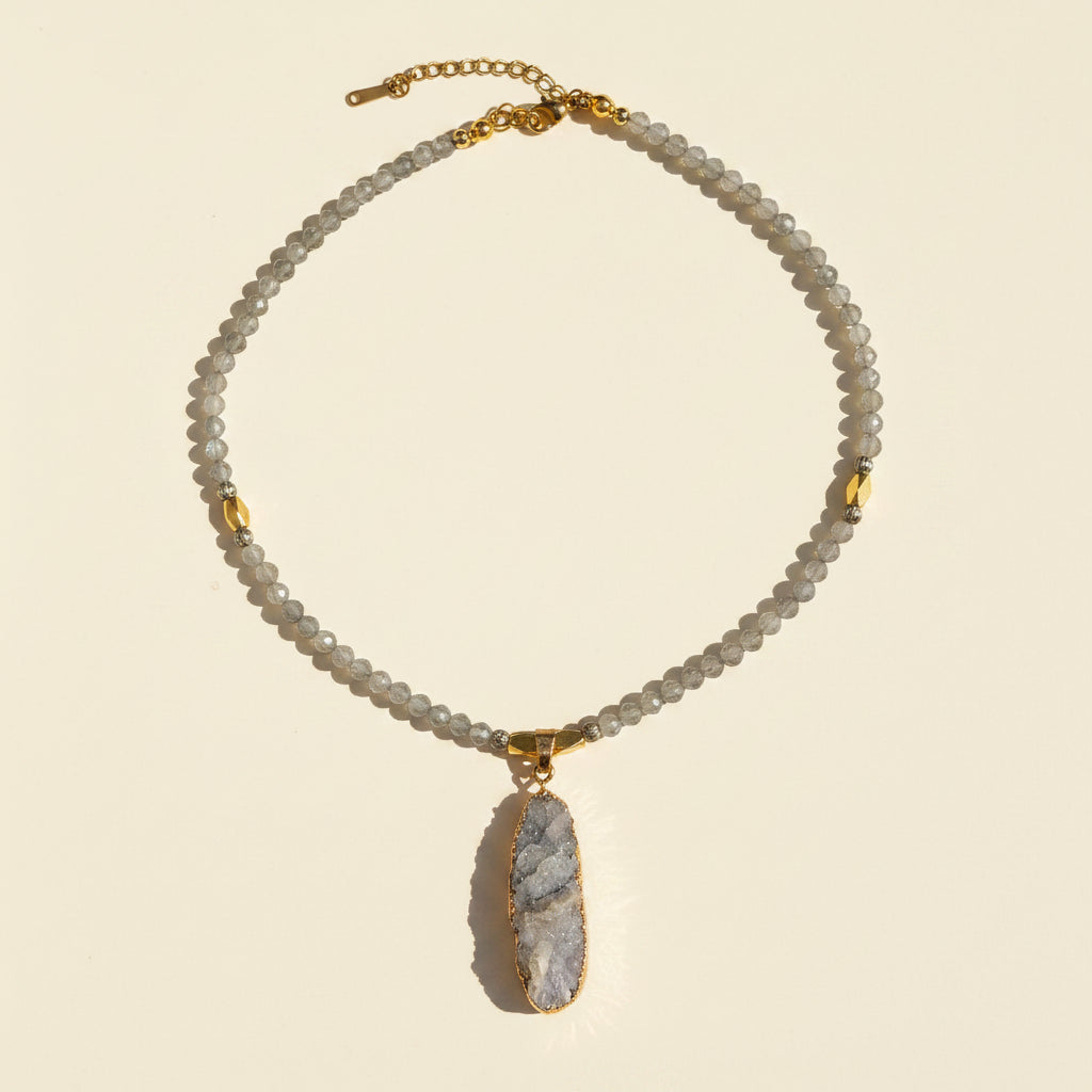 Full view of a gray labradorite necklace with a natural druzy pendant and gold-plated details