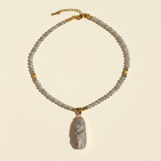 Full view of a gray labradorite necklace with a natural druzy pendant and gold-plated details