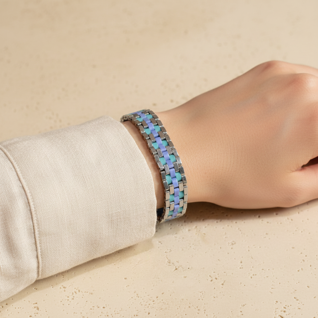 Tidal Mosaic statement Miyuki bracelet in aqua, blue and silver worn on wrist.