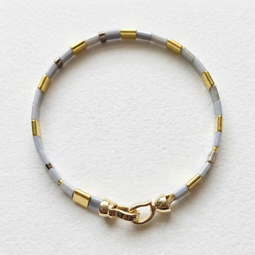Gold-tone clasp fastening on the handwoven Vertex Slim Miyuki bracelet