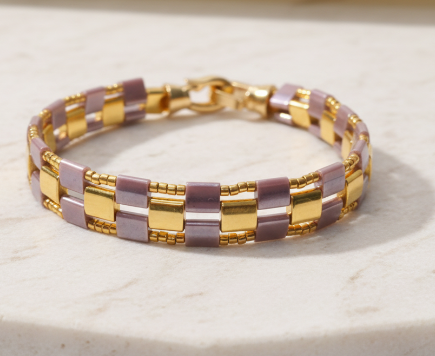 тове
Violette Grid bracelet handwoven with smoky mauve and gold Miyuki Tila beads